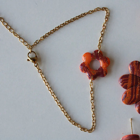 Pulsera flor estampado naranja y morado